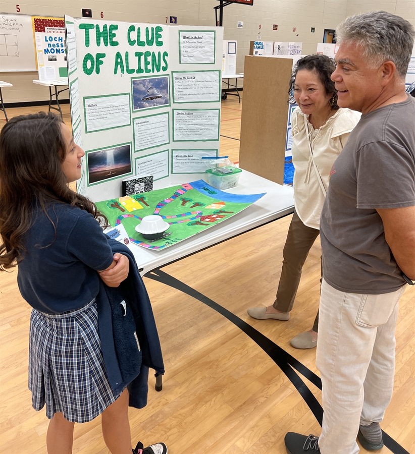 Elementary G/T student presents her project and game to community members.